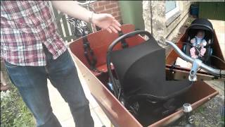 Carrying an infant in a Bakfiets using maxi cosi and rain tent [upl. by Yelehsa]