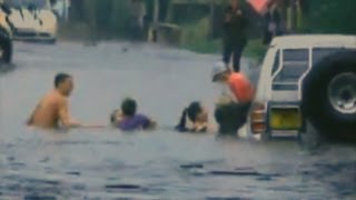 Children rescued after car becomes trapped in flood water [upl. by Ylrebmek]