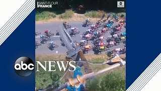 Daredevil mountain biker jumps over Tour de France  ABC News [upl. by Gnolb]