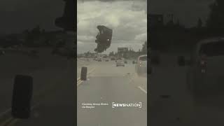 Car flips over after hitting tire lost by pickup on freeway [upl. by Pascale]