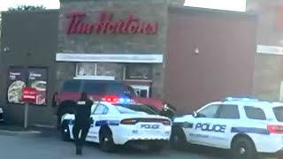 Wild getaway attempt at Tim Hortons drivethru  Suspect drives over police cruiser [upl. by Nora]