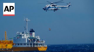 WATCH Japanese Coast Guard rescues swimmer swept out to sea [upl. by Suoicserp892]