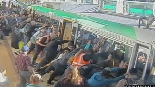 Mind the gap Commuters push train to save trapped man in Perth [upl. by Balfour344]