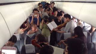 Philadelphia Orchestra musicians perform on flight waiting on Beijing tarmac [upl. by Felty]