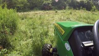 John Deere 1023e mowing tall wet grass [upl. by Brier728]