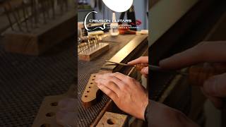 Installing guitar frets a very repetitive but satisfying process in Guitar Building luthier [upl. by Nelehyram]