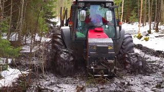 Valtra forestry tractor in wet forest in peat bog [upl. by Luisa]