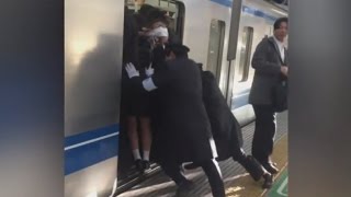 Professional Pushers Shove Passengers Onto Busy Tokyo Train [upl. by Aluin274]