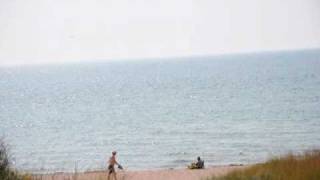 Woman Sunbathing on Beach at Ludington Michigan [upl. by Rothmuller206]