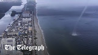 Waterspout crashes on to beach full of people in Miami Florida [upl. by Natanoj]