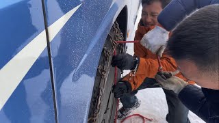 Putting chains on our bus on a snowcovered road at an elevation of 46465 meters [upl. by Edveh]