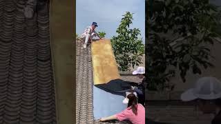 The process of paving self adhesive waterproof fabric on house roof [upl. by Suez]